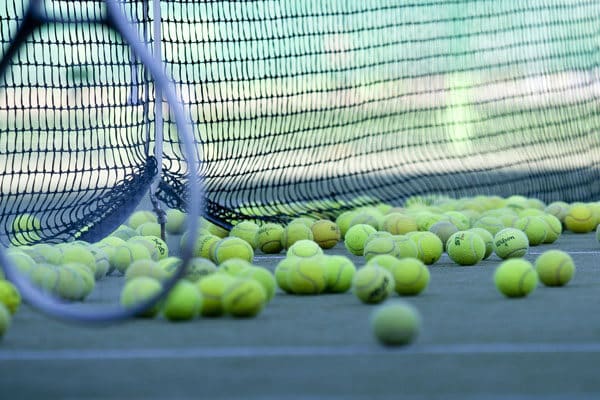 Tennis balls and court stock image
