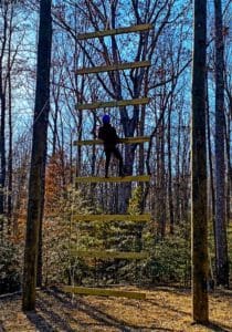 User on the Goliath Ladder at Wilderness Presidential Resort Adventure Park