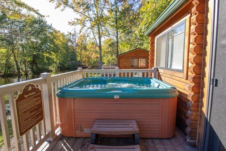 Private hot tub on a cabin deck overlooking Cool Springs Lake at Wilderness Presidential Resort