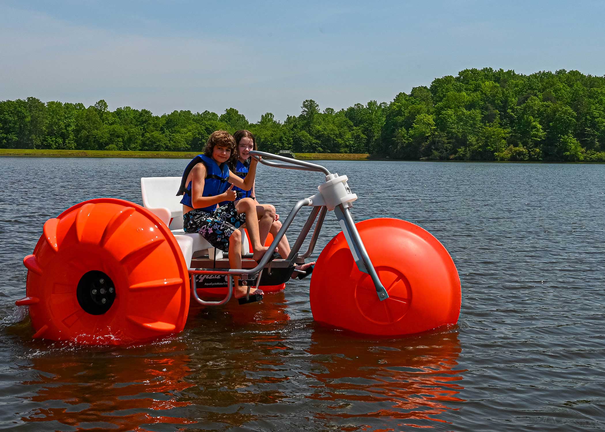 Kids enjoying aqua cycles on the lake at Wilderness Presidential Resort