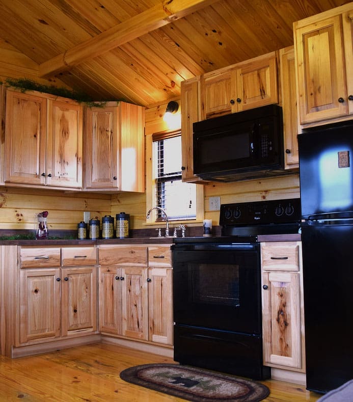 Fully equipped kitchen inside a lakeside camp cottage at Wilderness Presidential Resort