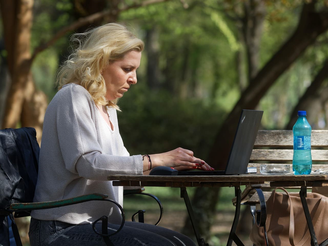 woman, working, park, outdoors, work from anywhere, laptop, caucasian