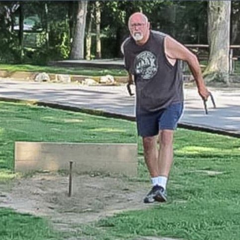Man playing horseshoes at Americamps RV Resort